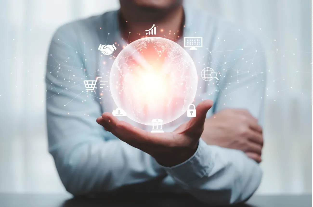 A man holds a glowing globe in his open palm, surrounded by digital icons for business and technology